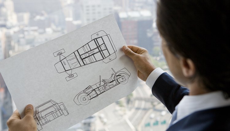 Businessman with car design plans