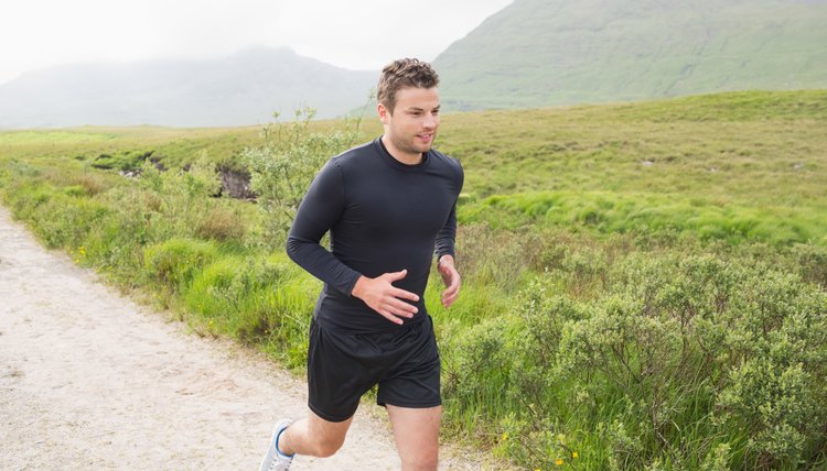 Fit man jogging on a trail