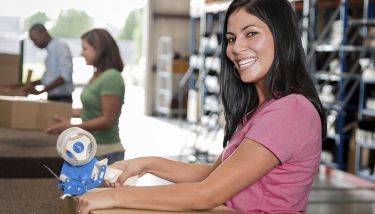 Young women taping a box