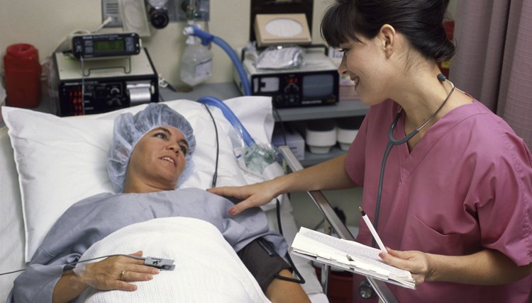Side profile of a female nurse examining a patient