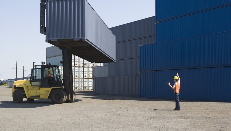 Workers stacking shipping containers