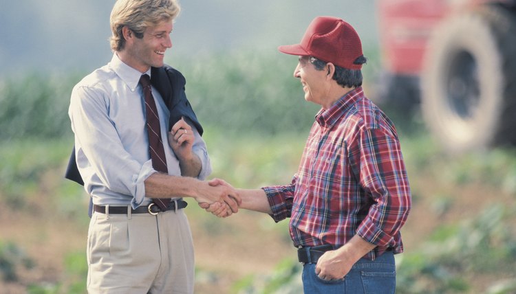 Farmer and businessman shaking hands