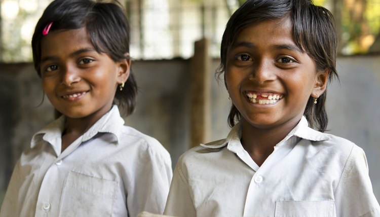 Beautiful girl reading in a school classroom ( India)