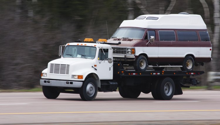 Flatbed truck transporting a van