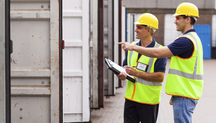 warehouse workers checking open containers