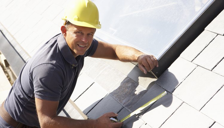 Roofer Working On Exterior Of New Home