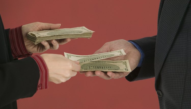 Hands exchanging money