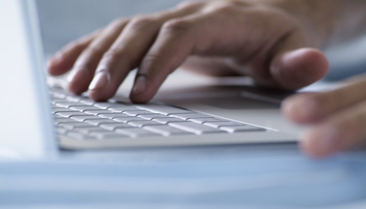 Hand on computer keyboard, close-up