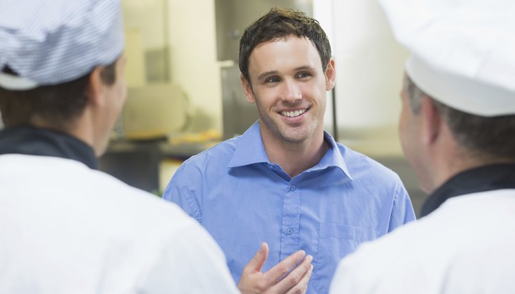 Young smiling manager talking to the staff