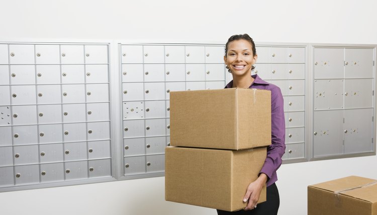 Businesswoman carrying cardboard boxes
