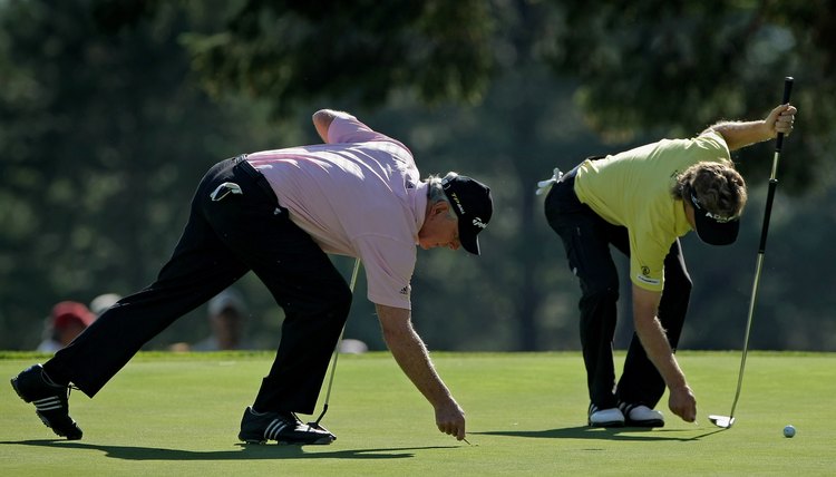 Hale Irwin and Bernhard Langer fix ball marks during the 2008 U.S. Senior Open.