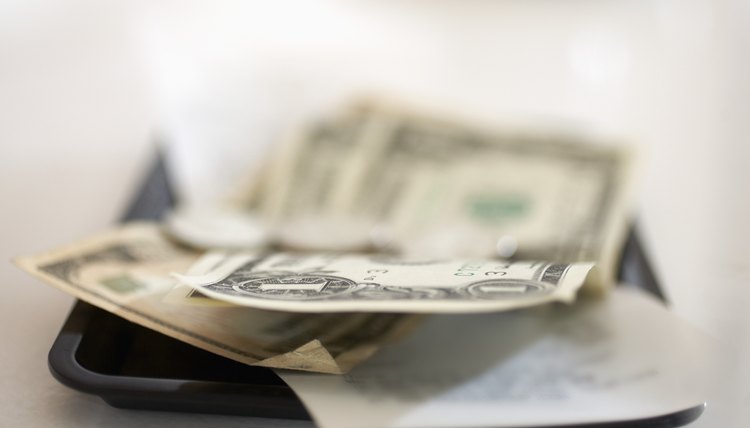 Dollar Bills and Coins on Tip Tray
