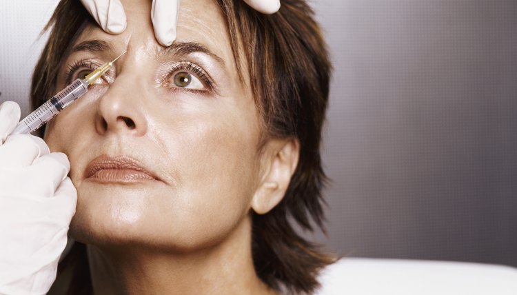 Mature Woman Receiving an Injection to Her Forehead