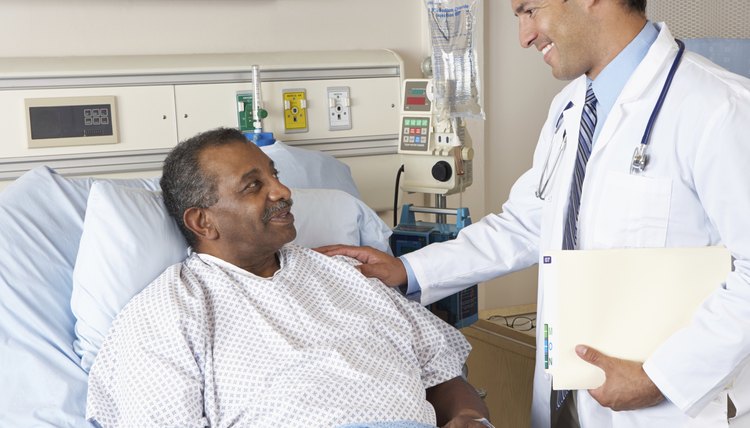 Doctor Visiting Senior Male Patient On Ward