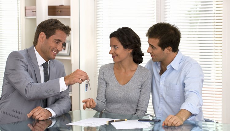 Real-estate agent giving keys to new property owners