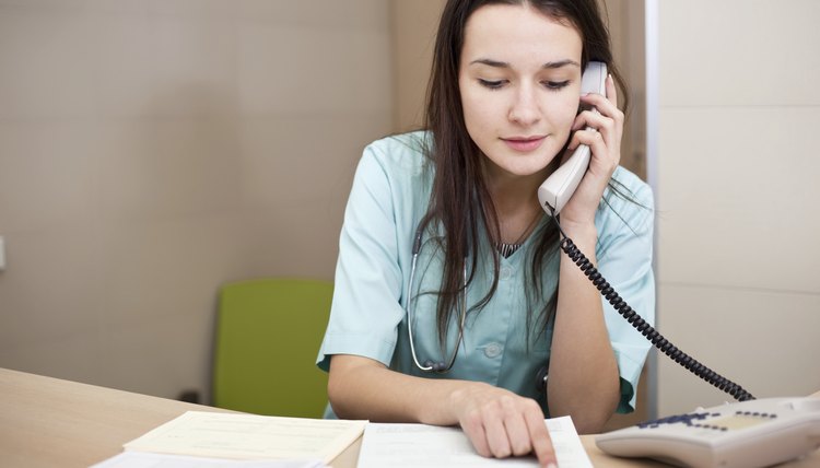 Smiling medical doctor or nurse talking on the phone