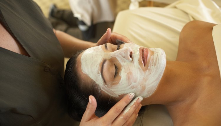 Woman receiving facial treatment in spa