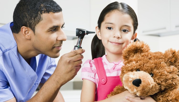 Doctor using otoscope