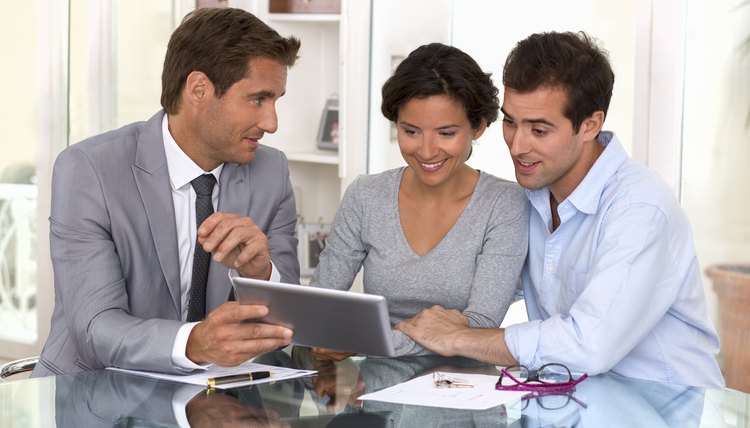 Architect presenting new project to a smiling young couple
