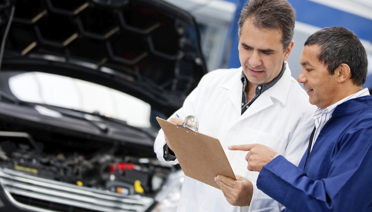 Mechanics fixing a car