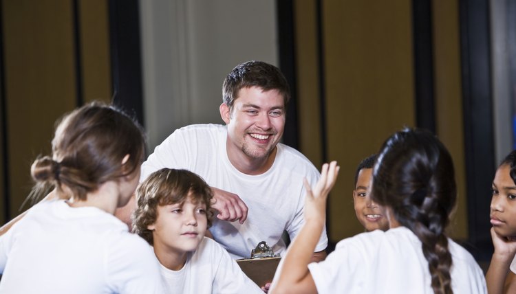 Diverse group of children in gym with coach