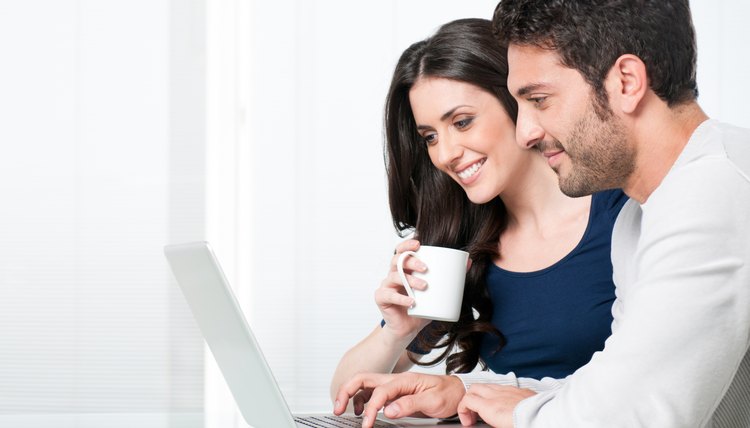Smiling couple with laptop