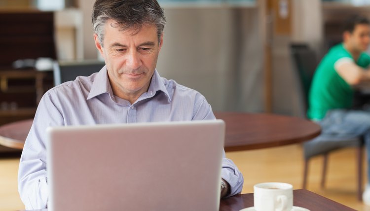 Man in a coffee shop working on the laptop