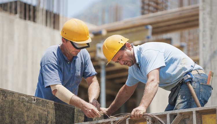 Construction workers working on cement formwork frames