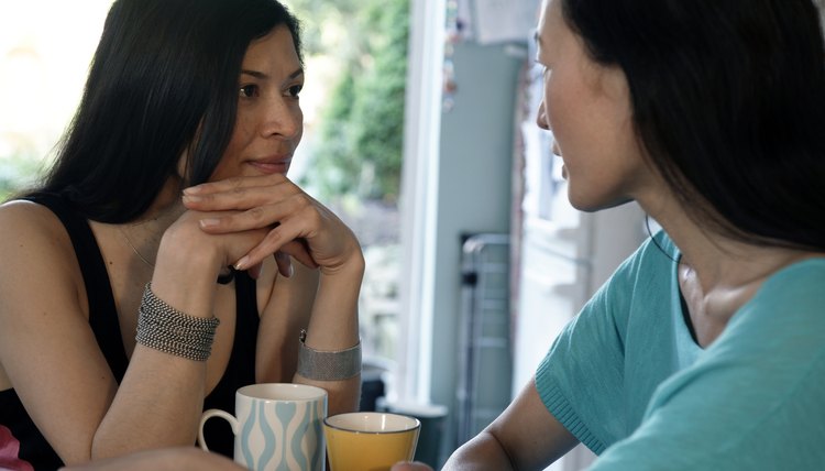 Two women sitting at table and talking