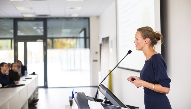 Pretty, young business woman giving a presentation