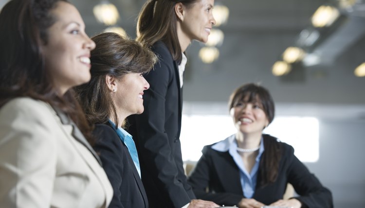 Four businesswomen in a meeting in the board room