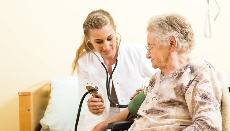 Young nurse and female senior in nursing home