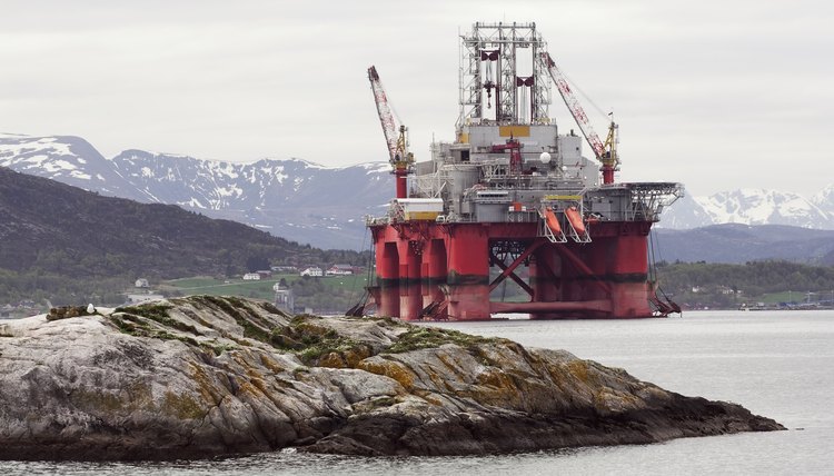 Oil rig in fjord landscape
