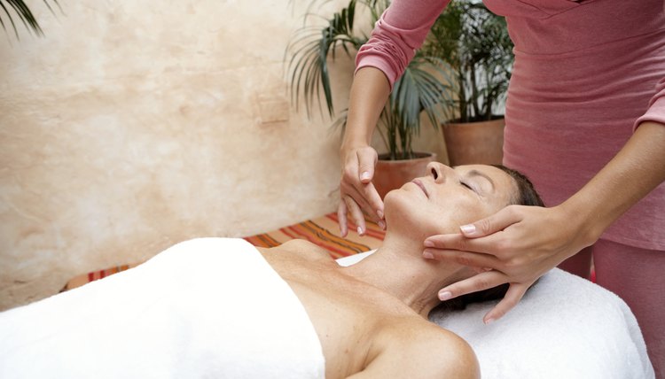 Mature woman receiving massage, eyes closed