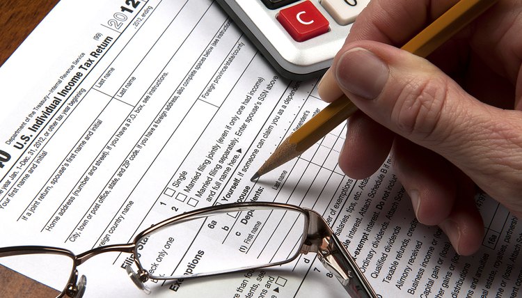 United States tax form with hand sharpened pencil calculator glasses