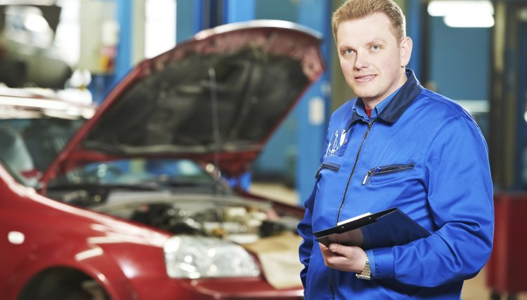 happy mechanic technician at service station