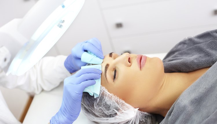 Young beautiful woman having facial beauty treatment