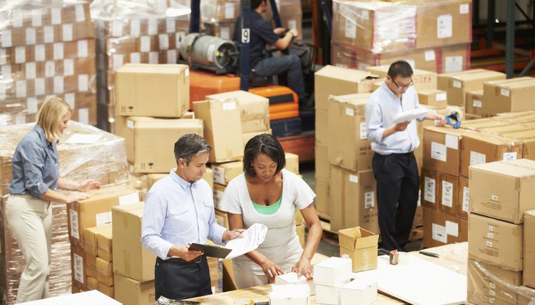Workers In Warehouse Preparing Goods For Dispatch