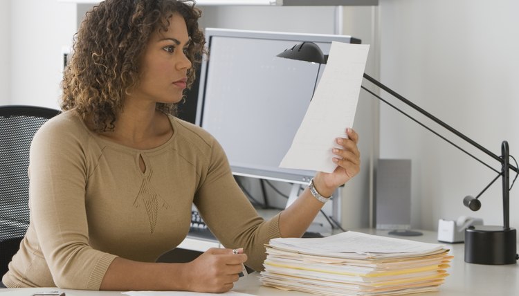 African businesswoman reading paperwork