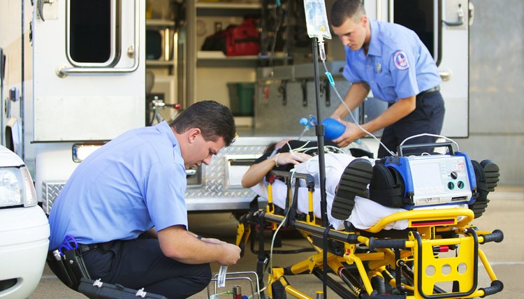 Paramedics loading patient into ambulance