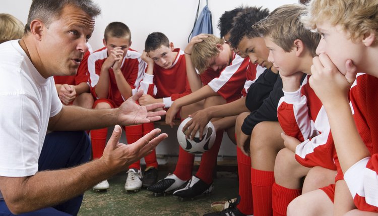 Coach talking to boys soccer team
