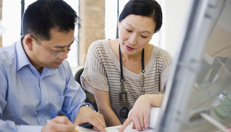 Businesspeople working on computer