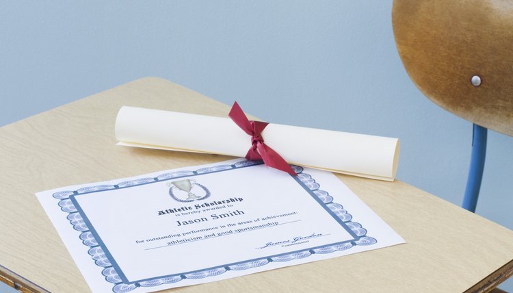 Diploma and certificate of achievement on school desk