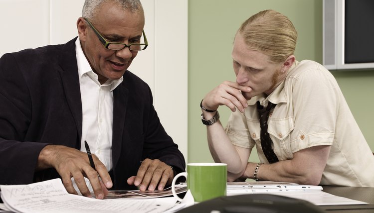 Young man speaking with a mature man in the office