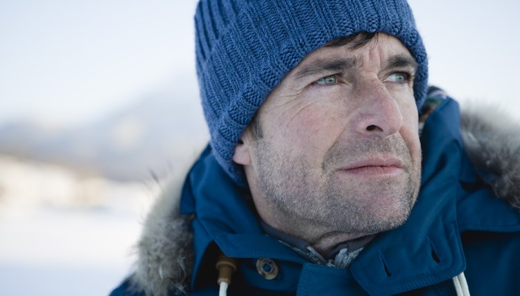 Mature man in blue hat, looking away