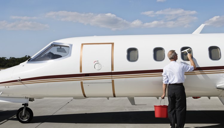 Businessman Cleaning Airplane Window