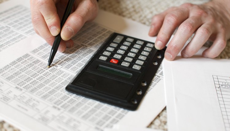 Man's hands and calculator