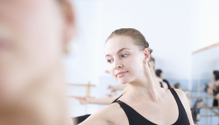 Young woman stretches into ballet pose