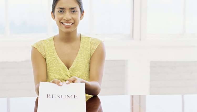 portrait of a young woman showing her resume