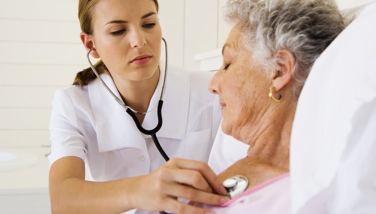 Nurse checking woman's heartbeat